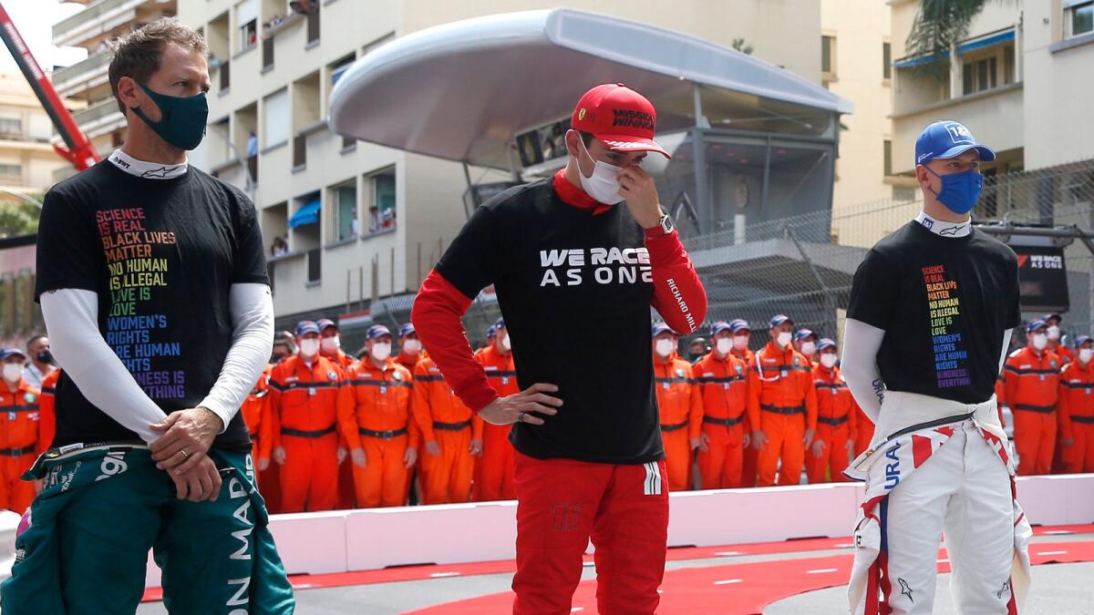 Ferrari driver Charles Leclerc of Monaco (centre) poses with Haas driver Mick Schumacher of Germany (right) and Aston Martin driver Sebastian Vettel of Germany during a ceremony prior to the start of the Monaco Grand Prix at the Monaco racetrack. — AP