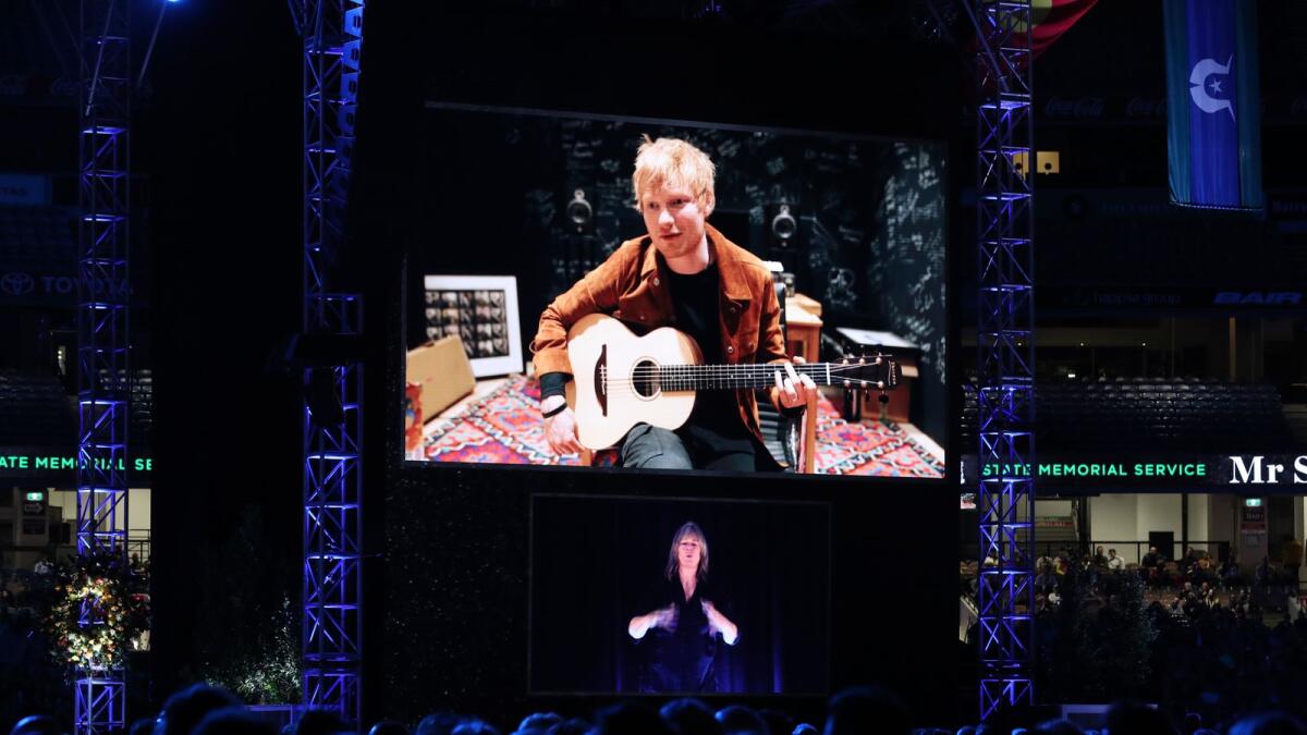 Musician Ed Sheeran performs via video link during the memorial service. — AP