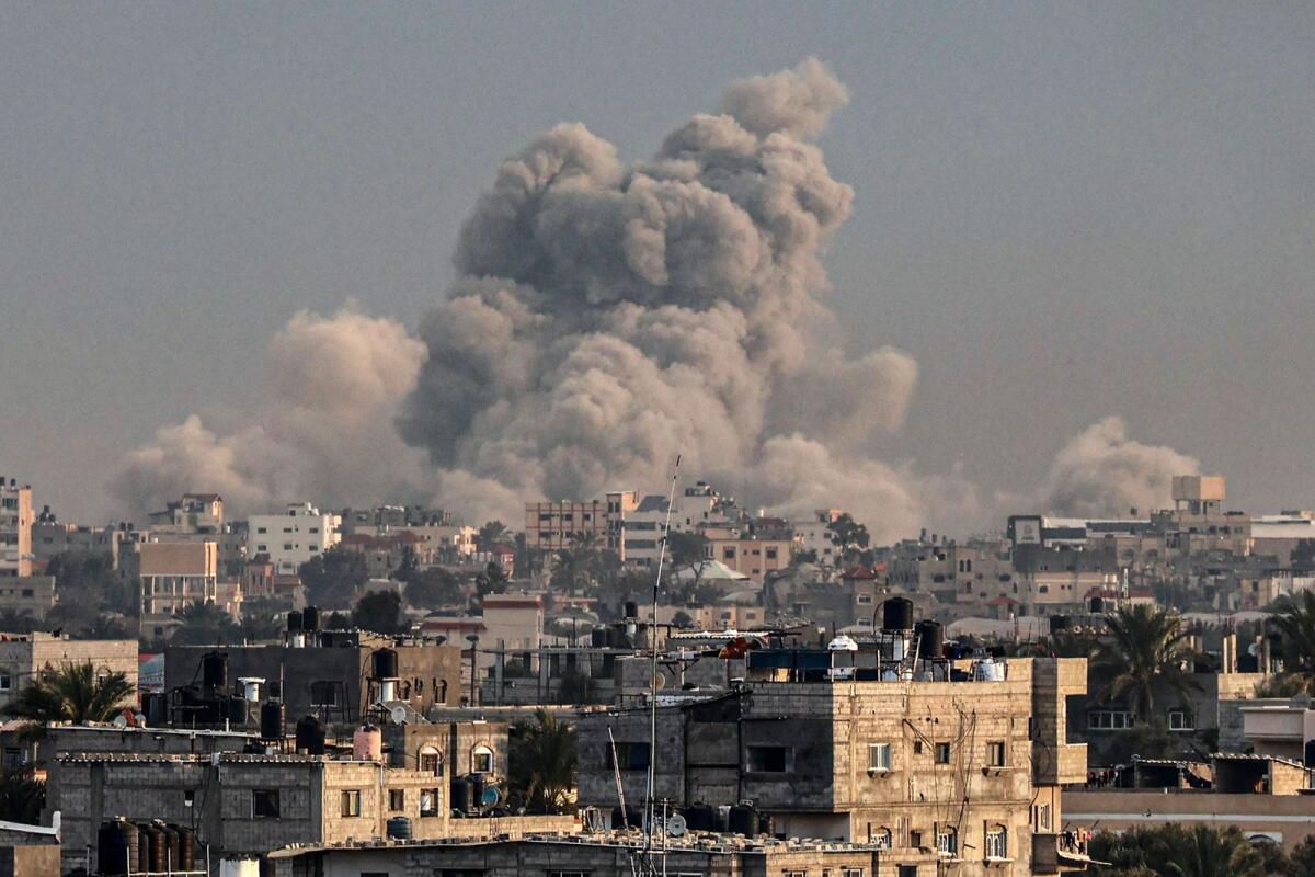 This photograph taken on January 15, 2024 from Rafah shows smoke billowing over Khan Yunis in the southern Gaza Strip during Israeli bombardment, amid ongoing battles between Israel and the Palestinian militant group Hamas.  (Photo by AFP)