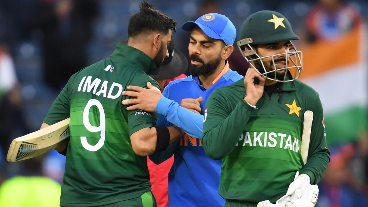 India's captain Virat Kohli (centre) embraces Pakistan's Imad Wasim after their victory in the 2019 World Cup group stage match. (AFP file)