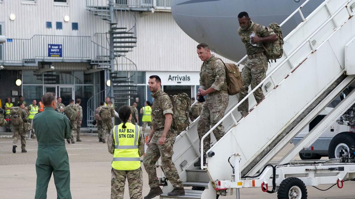 Members of the British armed forces disembark a Royal Air Force Voyager at RAF Brize Norton, west of London. Photo: AFP