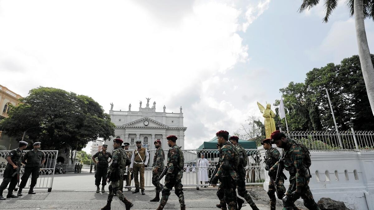 Sri Lankas commando soldiers walk near the main entrance of St. Lucia Cathedral.- Reuters