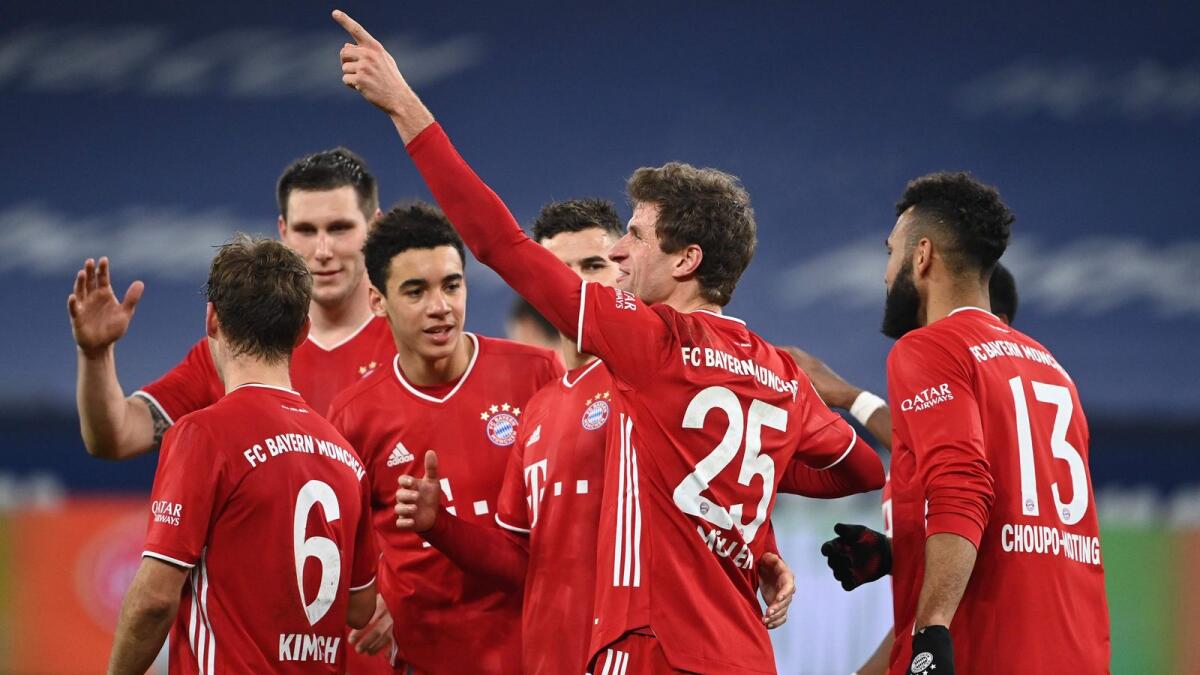Bayern Munich's German forward Thomas Mueller celebrates a goal with his teammates. — AFP