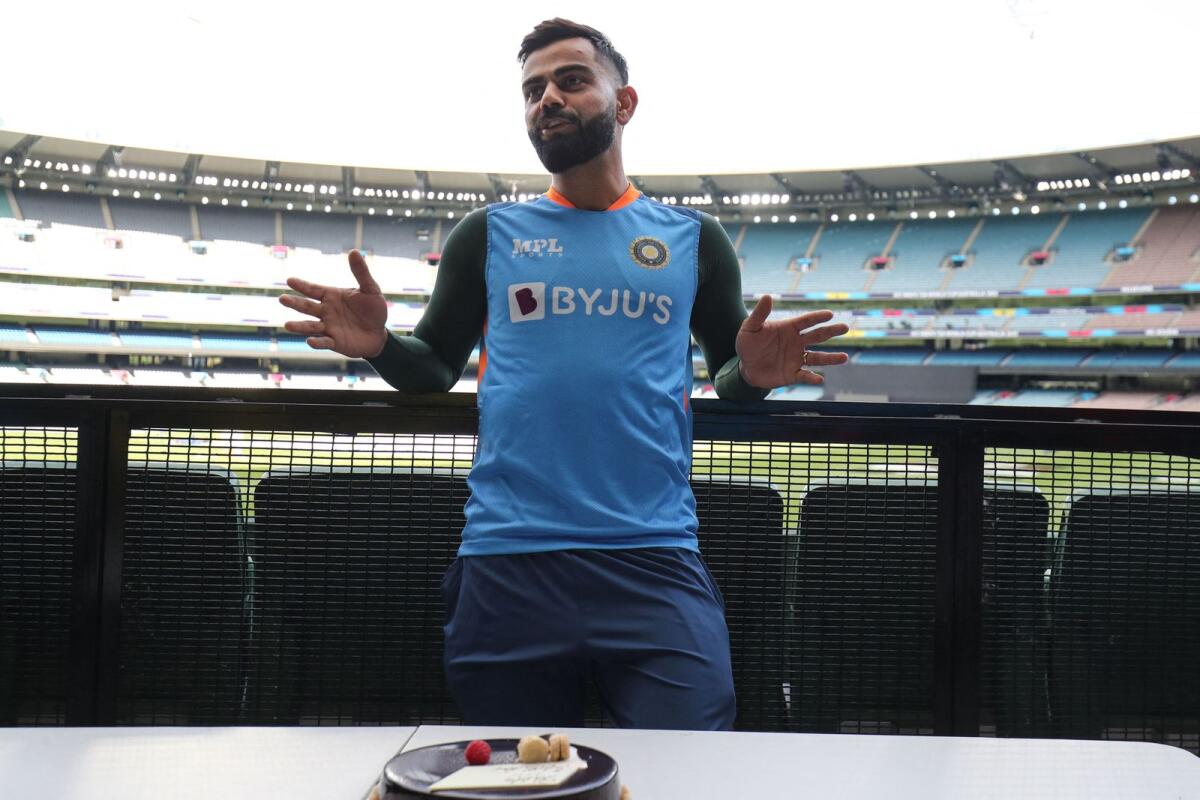 India's Virat Kohli after being presented with a birthday cake by the travelling India media, following a practice session at the Melbourne Cricket Ground on Saturday. — AFP