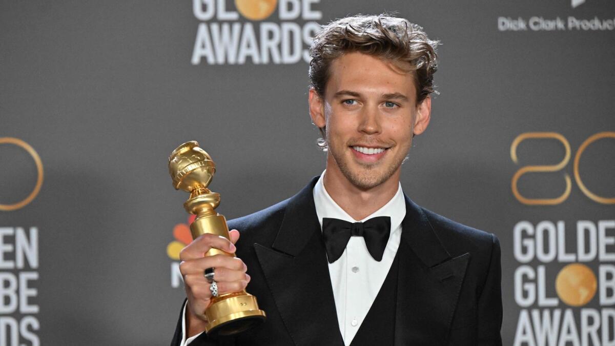 Austin Butler poses with the award for Best Actor - Motion Picture - Drama for 'Elvis'