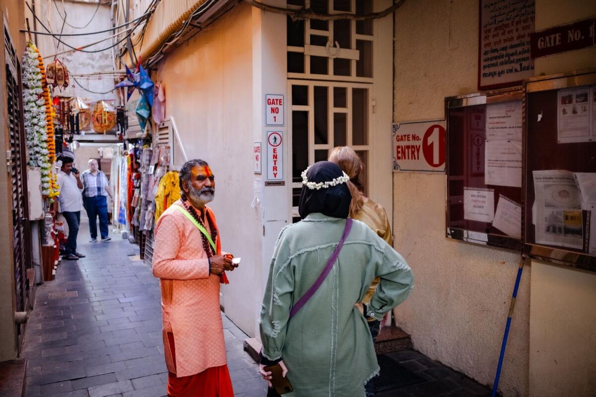 Devotees stand outside one of the gates of the iconic Bur Dubai Hindu temple as the services shift to the new premises in Jebel Ali from January 3. KT Photo: Shihab