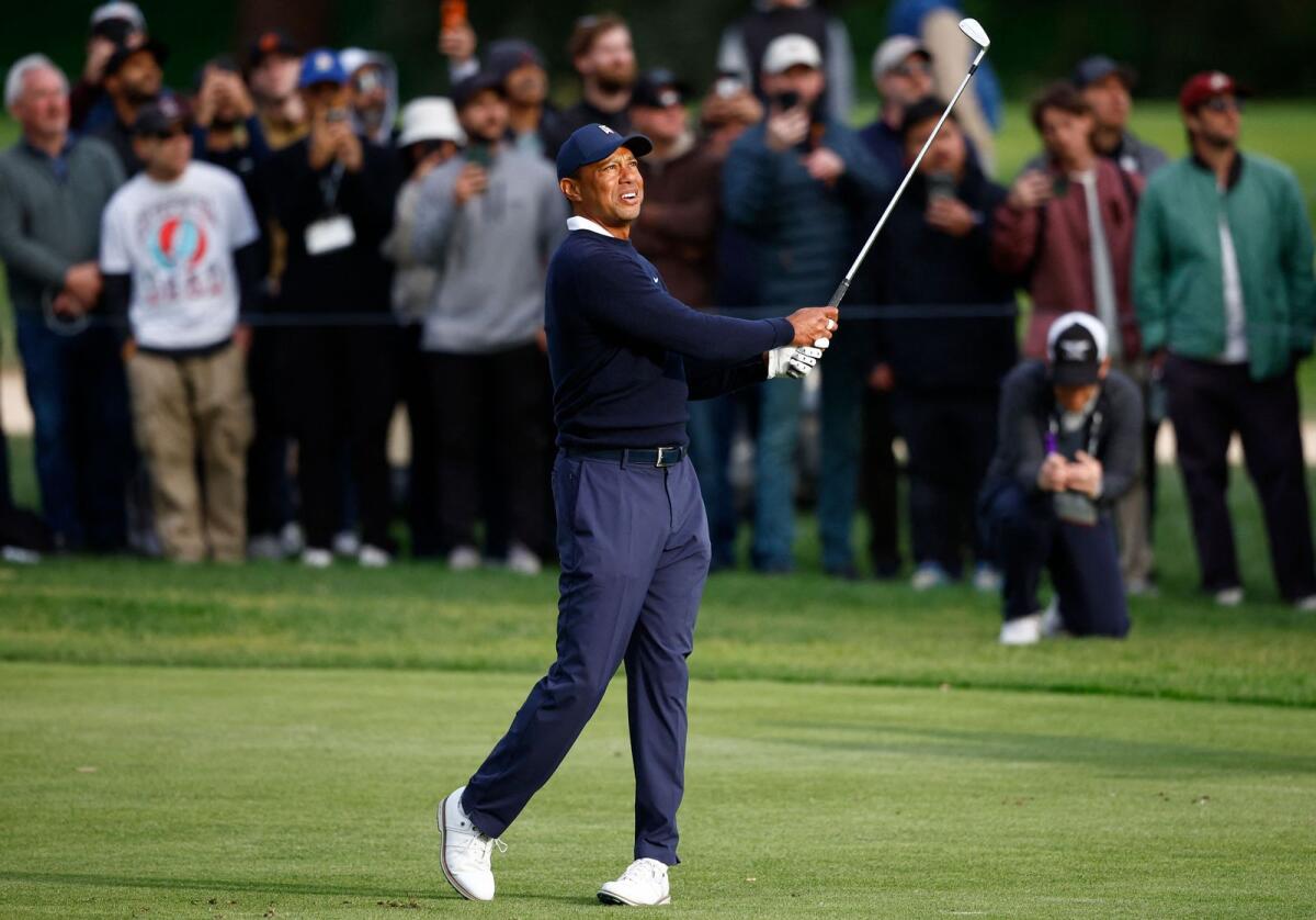 Tiger Woods plays his shot on the 15th hole during the first round. — AFP