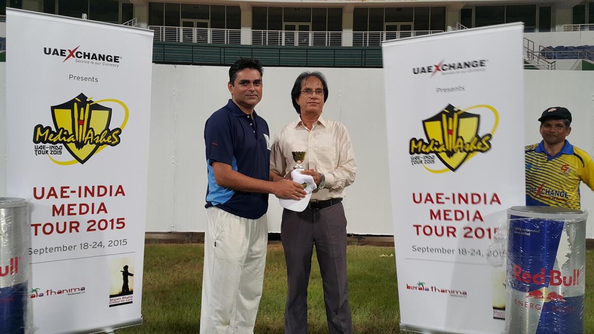 Sanjeev Samyal (left) receiving the man of the match award from Abu Dhabi Cricket Council’s Shahnawaz Hakim. 