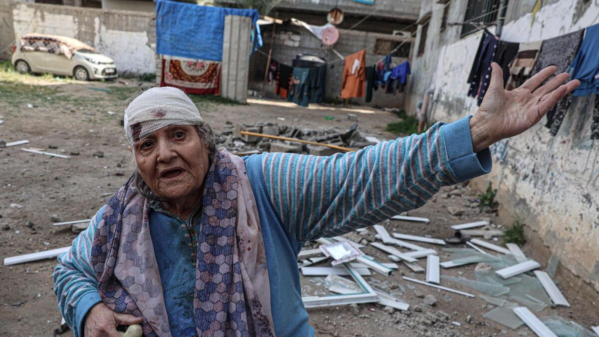 75-year-old Palestinian Hoda Al Arouqi, who was injured as a result of overnight Israeli bombardment, inspects the damage to her home in Rafah. — AFP
