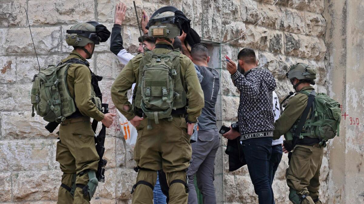 Israeli forces stop and search Palestinian youths in the village of Haris in the occupied West Bank following an attack in which a Palestinian killed two Israelis. — AFP