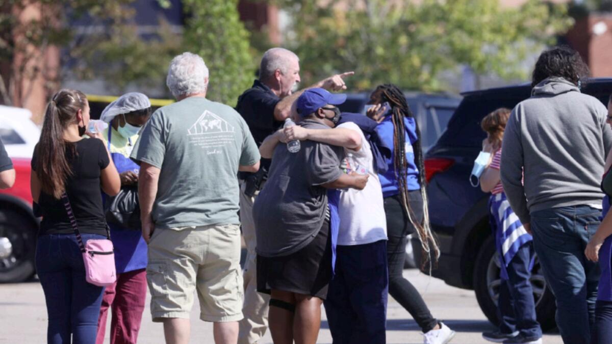 People embrace as police respond to the scene of a shooting at a Kroger's grocery store in Collierville, Tennessee. — AP
