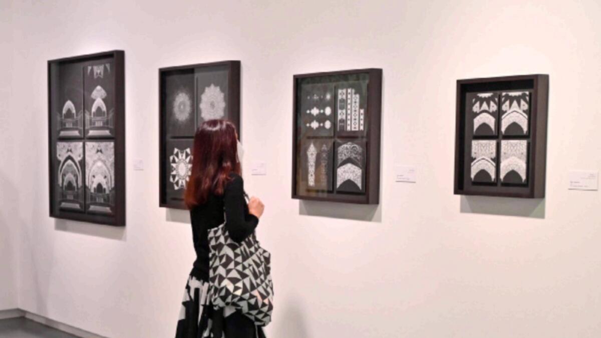 A visitor seems absorbed in an artwork on the  opening day of the Sharjah Islamic Arts Festival (SIAF). About 248 artworks by 63 artists from 27 countries are being showcased at the festival.