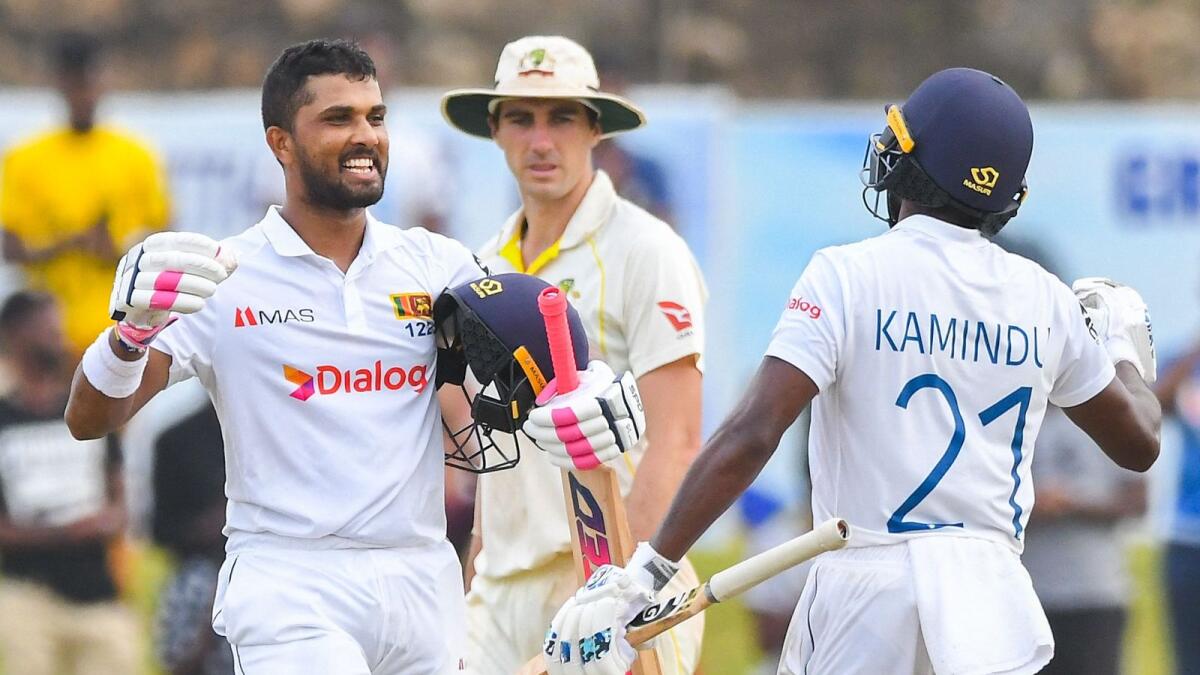 Sri Lanka's Dinesh Chandimal (left) celebrates with Kamindu Mendis after scoring a century. (AFP)