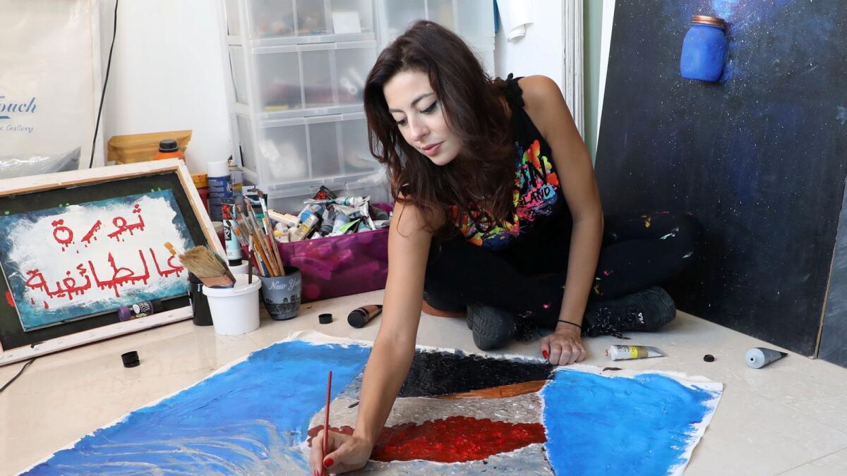 Lebanese artist, Hayat Nazer, paints as she attends an interview with Reuters in Beirut, Lebanon on November 10, 2020.