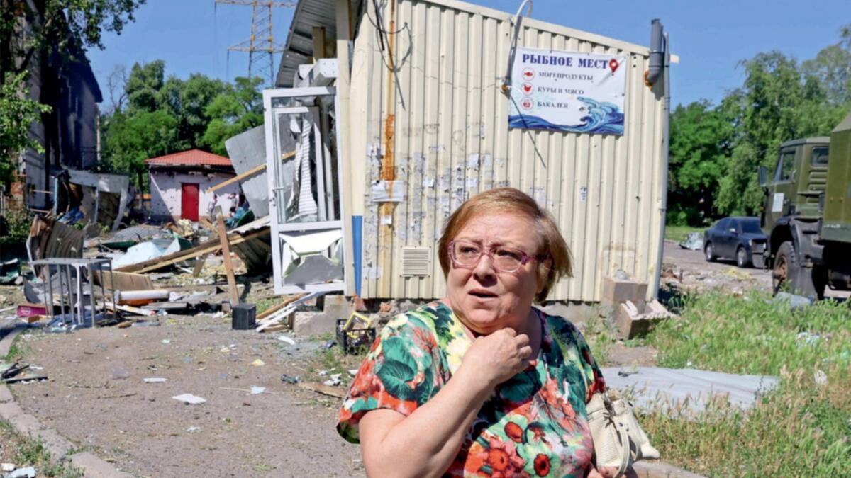 A woman walks past destroyed structures at a local market following recent shelling in the course of Ukraine-Russia conflict in Donetsk. — Reuters