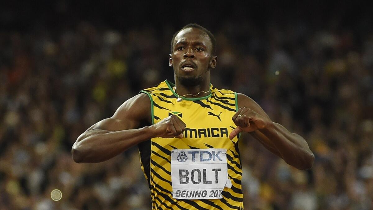 TOPSHOTSJamaica's Usain Bolt celebrates after winning the final of the men's 200 metres athletics event at the 2015 IAAF World Championships at the 'Bird's Nest' National Stadium in Beijing on August 27, 2015. AFP PHOTO / OLIVIER MORIN