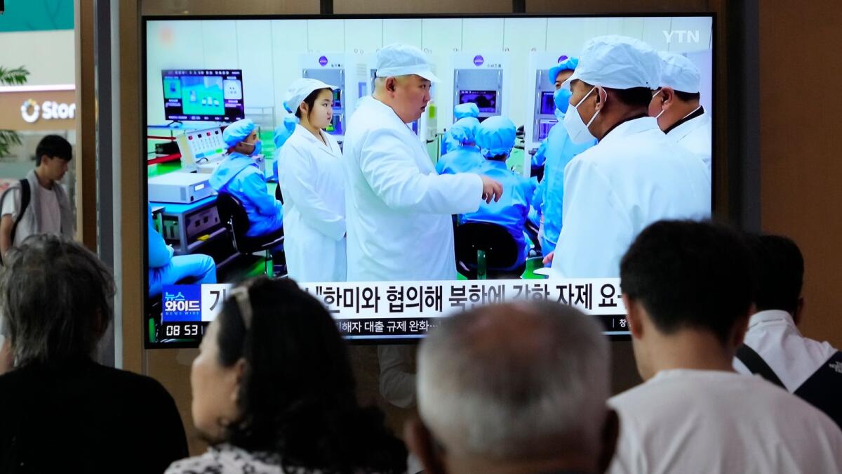 A TV screen shows a file image of North Korean leader Kim Jong Un, third from left, during a news program at the Seoul Railway Station in Seoul, South Korea, on Monday. AP