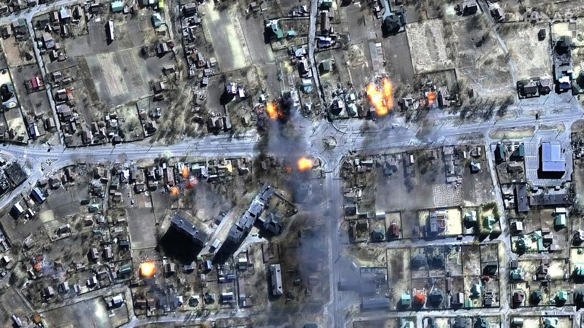 This Maxar satellite image taken and released on March 16, 2022 shows a multispectral image view of burning homes in a residential area of Chernihiv, Ukraine. - On the 21st day of Russia's invasion of Ukraine on March 16, Russian forces remained in place around major cities including Kyiv but showed little sign of real progress in taking them. Photo: AFP