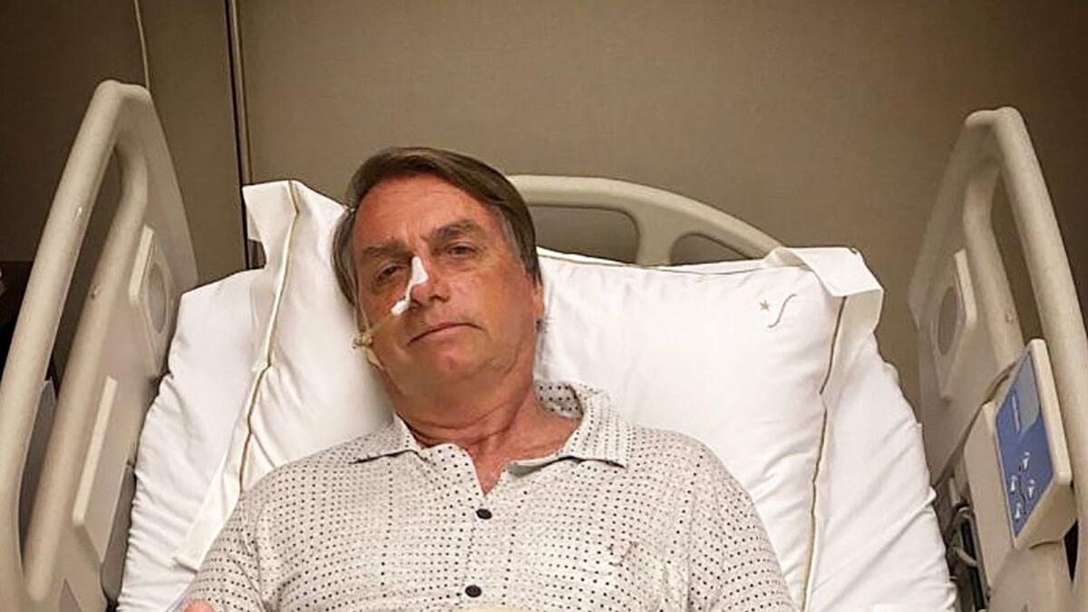 This picture obtained from the twitter official account of Brazil's President Jair Bolsonaro (@jairbolsonaro), shows Brazil's President Jair Bolsonaro posing for a picture while hospitalized due to an intestinal obstruction, in Sao Paulo, Brazil, on January 3, 2021. - Brazilian President Jair Bolsonaro was rushed to hospital early on January 3 with abdominal pain that doctors found was caused by an intestinal blockage, and is facing potential surgery nine months out from elections. (Photo by - / Jair Bolsonaro's official Twitter account / AFP) / NO USE AFTER JANUARY 13, 2022 16:11:40 GMT - RESTRICTED TO EDITORIAL USE - MANDATORY CREDIT 'AFP PHOTO / JAIR BOLSONARO'S OFFICIAL TWITTER ACCOUNT (@JAIRBOLSONARO) ' - NO MARKETING - NO ADVERTISING CAMPAIGNS - DISTRIBUTED AS A SERVICE TO CLIENTS - NO ARCHIVES - RESTRICTED TO EDITORIAL USE - MANDATORY CREDIT 'AFP PHOTO / Jair Bolsonaro's official Twitter account (@jairbolsonaro) ' - NO MARKETING - NO ADVERTISING CAMPAIGNS - DISTRIBUTED AS A SERVICE TO CLIENTS - NO ARCHIVES /