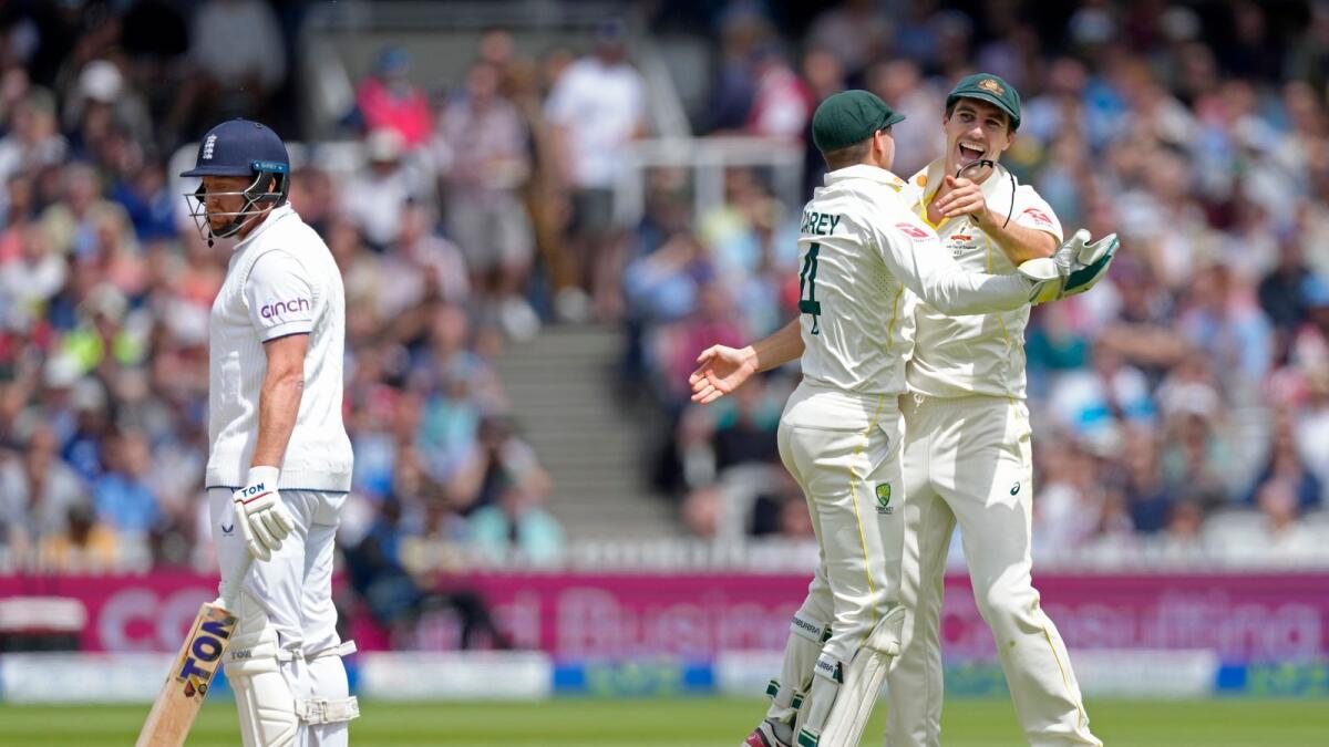 Australia's captain Pat Cummins (right) celebrates with teammate Alex Carey after the dismissal of England's Jonny Bairstow at Lord's. — AP