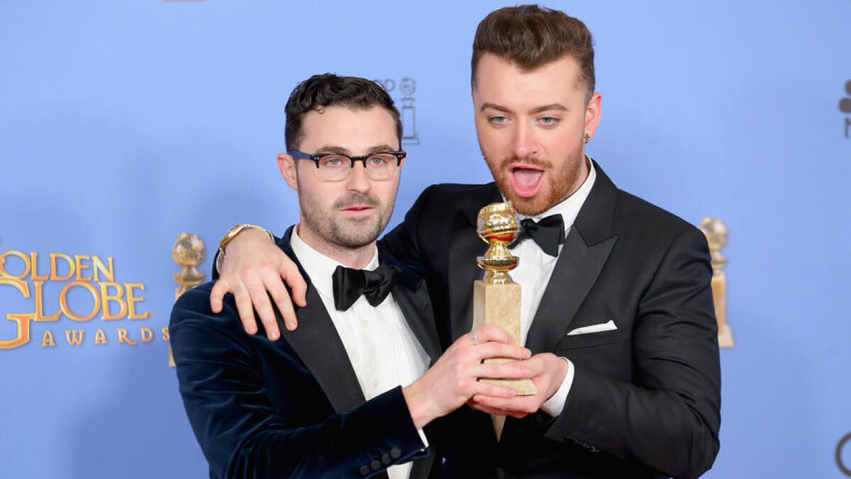 Songwriter Jimmy Napes (L) and recording artist Sam Smith, winners of Best Original Song - Motion Picture for Writing's On the Wall in Spectre. Photo: AFP