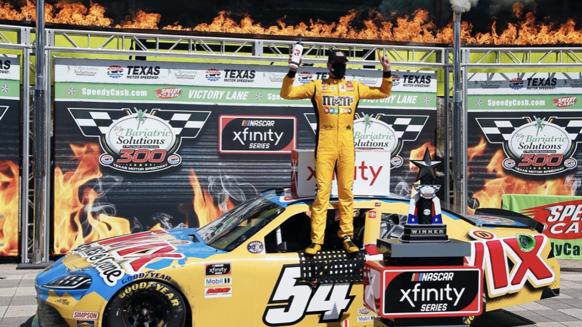 Kyle Busch celebrates in Victory Lane after winning the NASCAR Xfinity auto race at Texas Motor Speedway in Fort Worth, Texas.  Kyle Busch celebrated a 10th NASCAR Xfinity Series victory at Texas, and then had it taken away. Busch failed postrace tech inspection Saturday after finishing ahead of Austin Cindric, who was declared the winner for the third victory in a row after winning both Xfinity races at Kentucky. Photo: AP