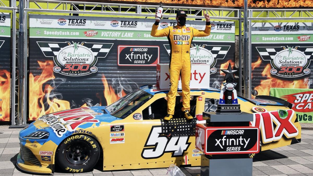 Kyle Busch celebrates in Victory Lane after winning the NASCAR Xfinity auto race at Texas Motor Speedway in Fort Worth, Texas.  Kyle Busch celebrated a 10th NASCAR Xfinity Series victory at Texas, and then had it taken away. Busch failed postrace tech inspection Saturday after finishing ahead of Austin Cindric, who was declared the winner for the third victory in a row after winning both Xfinity races at Kentucky. Photo: AP