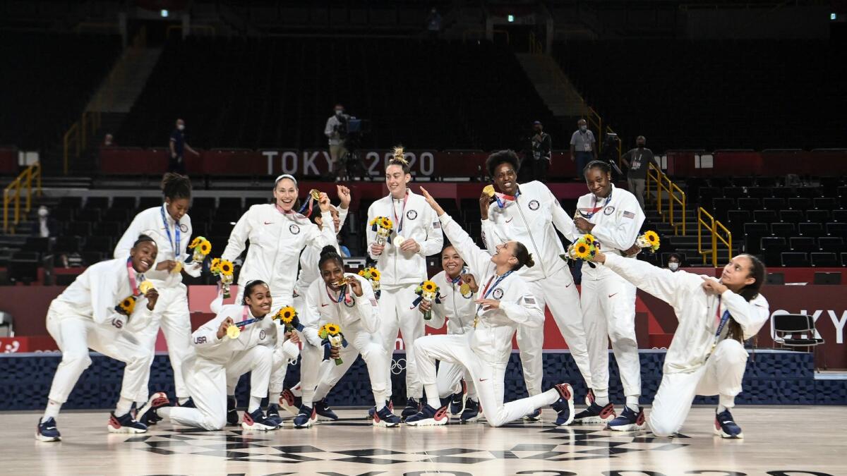First placed USA's players pose for pictures with their gold medals after the medal ceremony for the women's basketball competition. — AFP