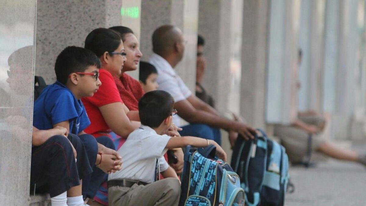 The students and their parents await the arrival of their school bus in Sharjah.- Photo by M.Sajjad/ Khaleej Times