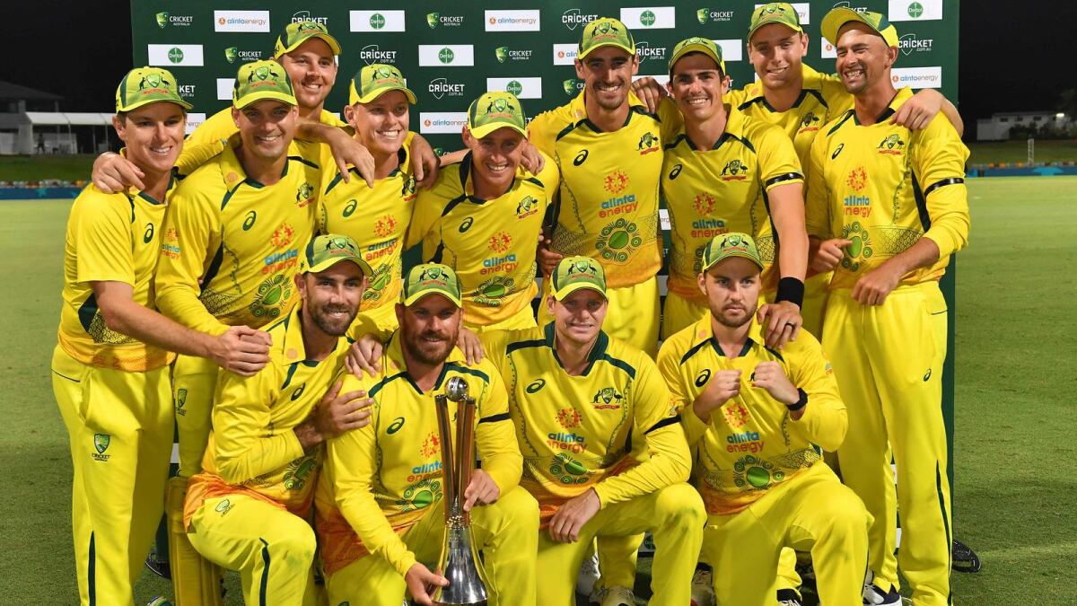 Australia's captain Aaron Finch holds the Chappell-Hadlee Trophy as he celebrates with teammates. — AFP