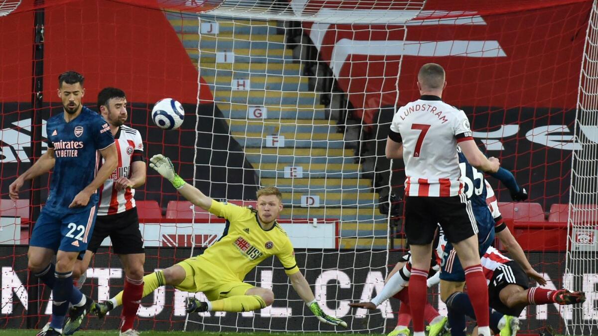 Sheffield United's goalkeeper Aaron Ramsdale fails to stop a shot by Arsenal's Gabriel Martinelli.— AP