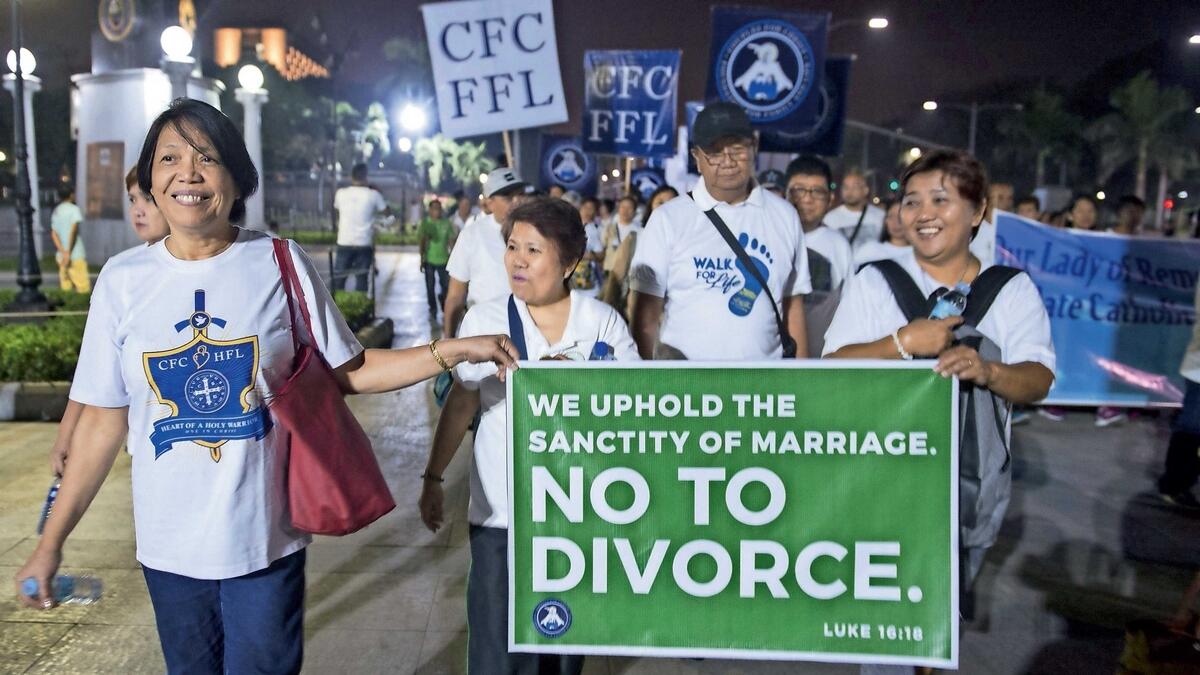 Philippine Catholics holding a banner as they take part in a ‘Walk for Life’ protest at a park in Manila. — AFP