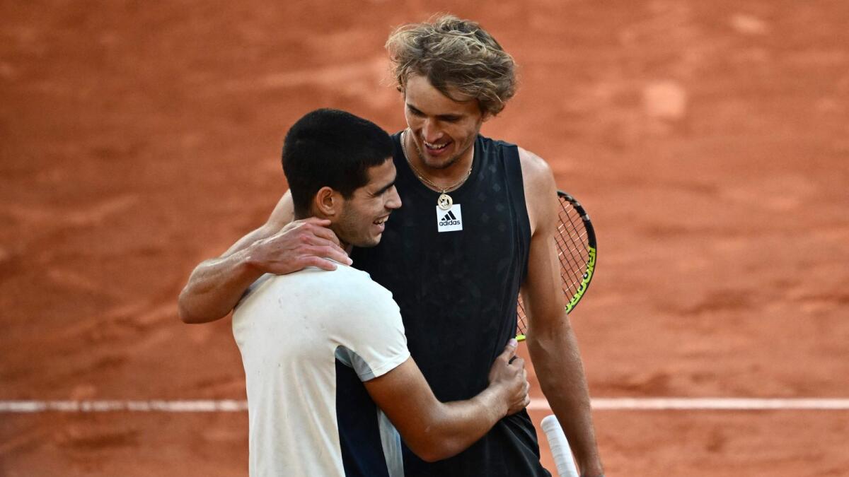 Germany's Alexander Zverev (right) greets Spain's Carlos Alcaraz after winning their men's quarterfinal at the French Open in Paris on Tuesday. — AFP