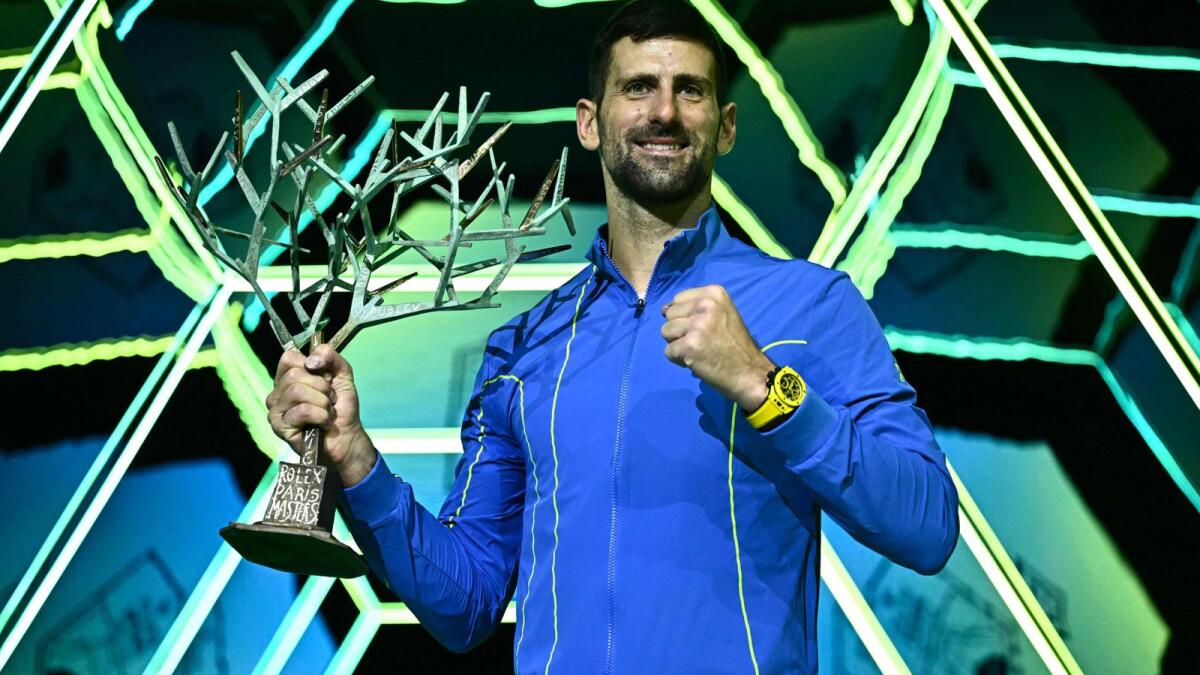 Serbia's Novak Djokovic poses with the trophy after winning the men's final match of the Paris ATP Masters on Sunday. - AFP