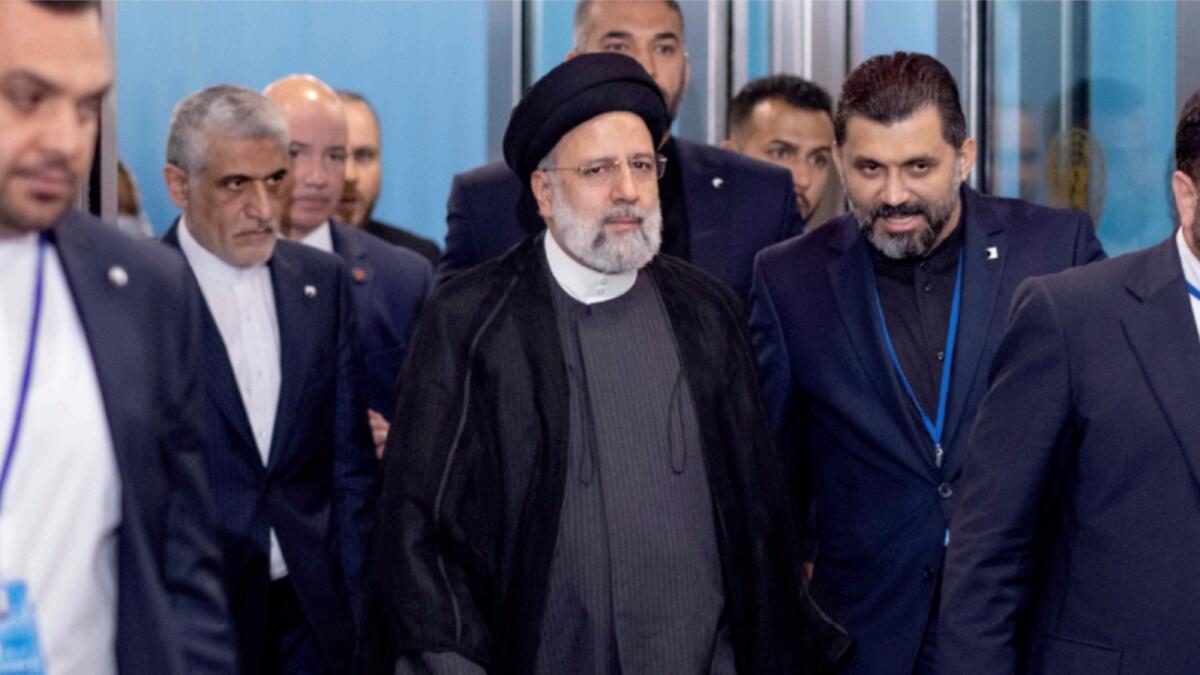 President of Iran Ebrahim Raisi, center, is escorted at United Nations headquarters. — AP