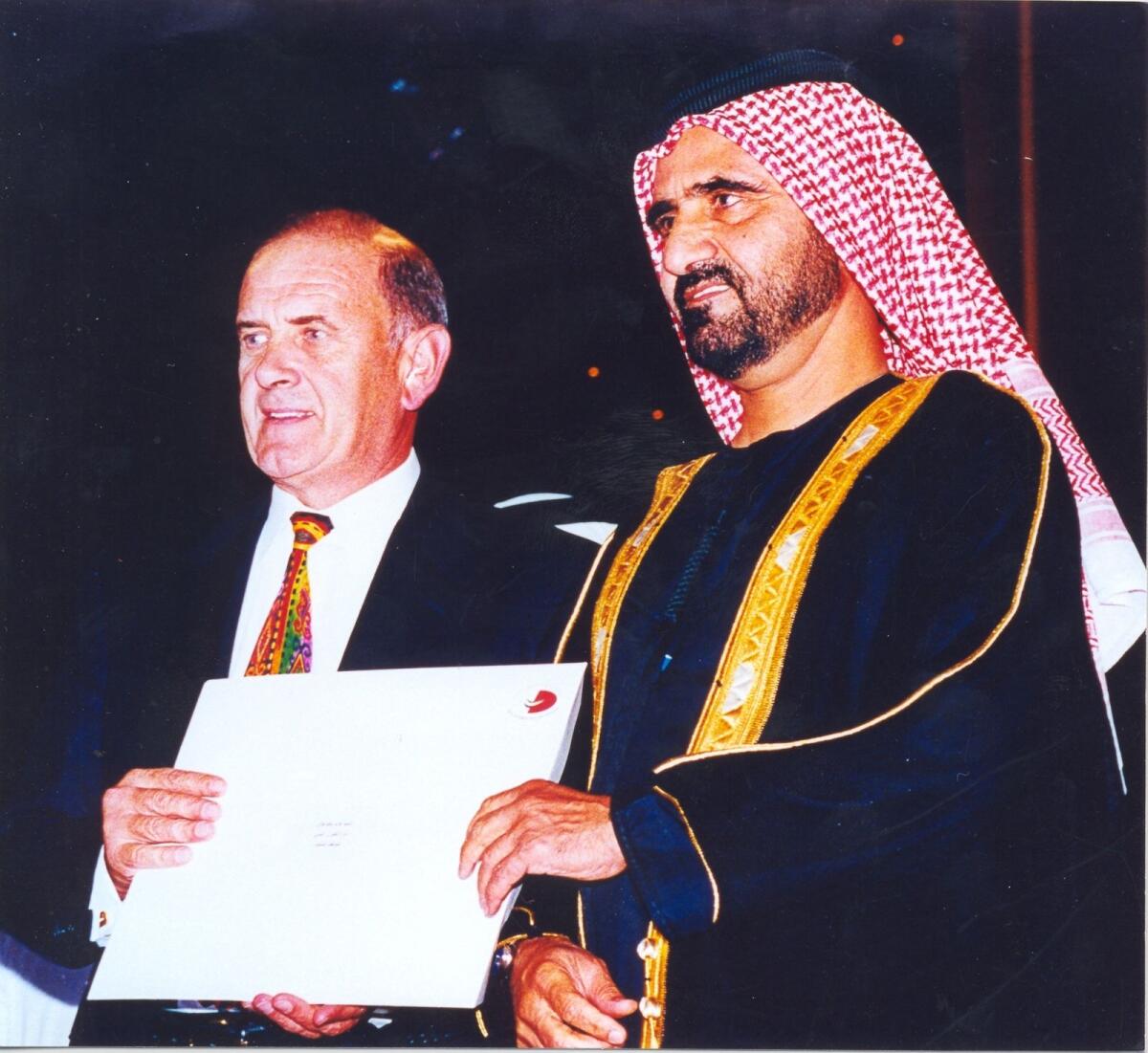 His Highness Sheikh Mohammed bin Rashid Al Maktoum, Vice-President and Prime Minister of the UAE and Ruler of Dubai (then Crown Prince of Dubai and UAE Minister of Defence) presents Colm McLoughlin (then Managing Director), Dubai Duty Free, with “The Most Distinguished Employee Award” from the Dubai Government, making him the first expatriate to receive the award. Photo: Supplied
