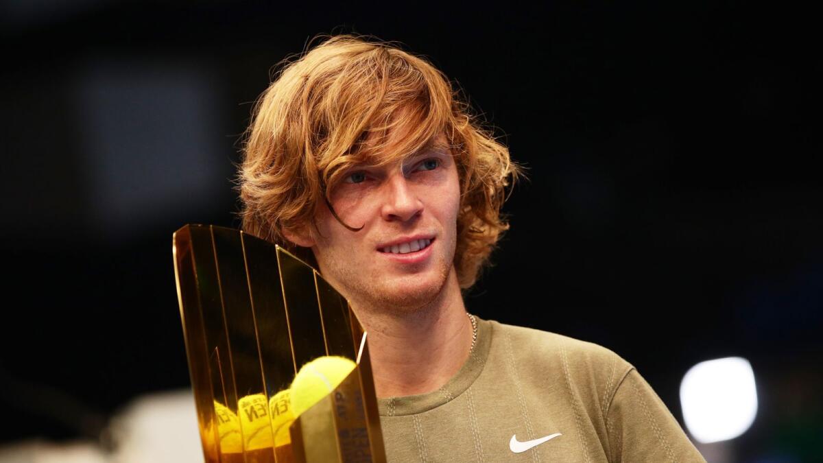 Russia's Andrey Rublev celebrates with the trophy after winning the final against Italy's Lorenzo Sonego. — Reuters