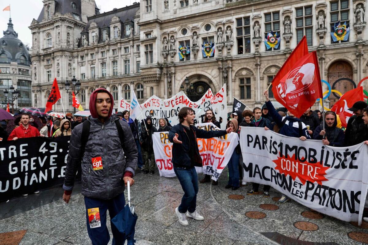 Protestors gather in front of Paris' city hall ahead of the results of a ruling from France's Constitutional Council on a contested pension reform in Paris on Friday. — AFP