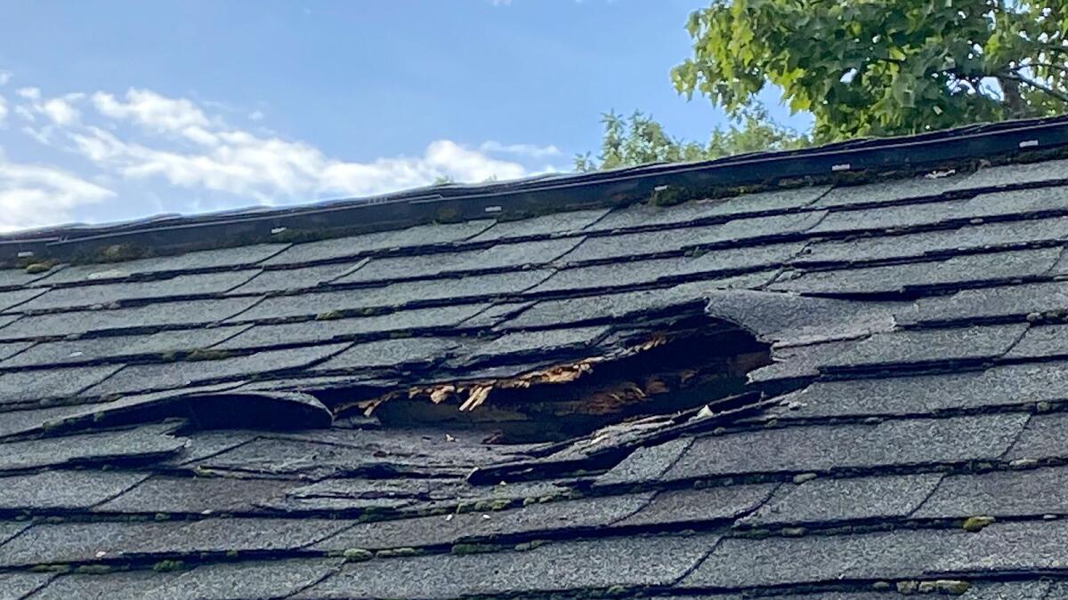 Photo provided by Jeff Ilg shows damage to his home in Shirley, Massachusetts, where a chunk of ice landed on the roof on August 13, 2023. — AP