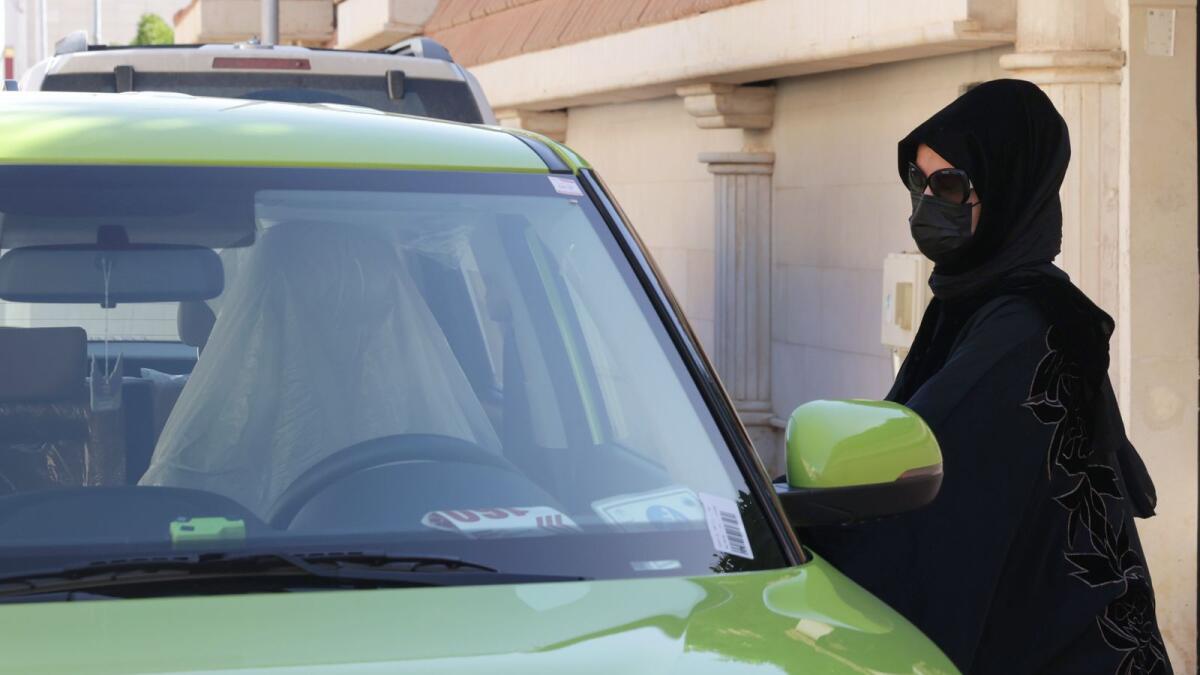 Saudi taxi driver Fahda Fahd goes into her car in the capital Riyadh, on February 8, 2022. Photo: AFP