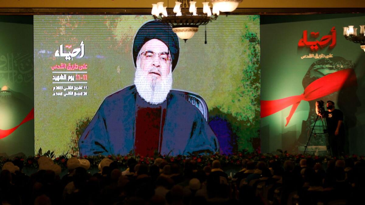 Lebanon's Hezbollah leader Sayyed Hassan Nasrallah addresses his supporters through a screen during a rally commemorating the annual Hezbollah Martyrs' Day in Nabatieh, Lebanon on Saturday. — Reuters