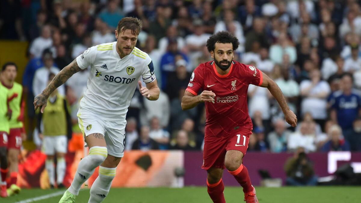 Leeds United's Liam Cooper vies for the ball with Liverpool's Mohamed Salah.— AP