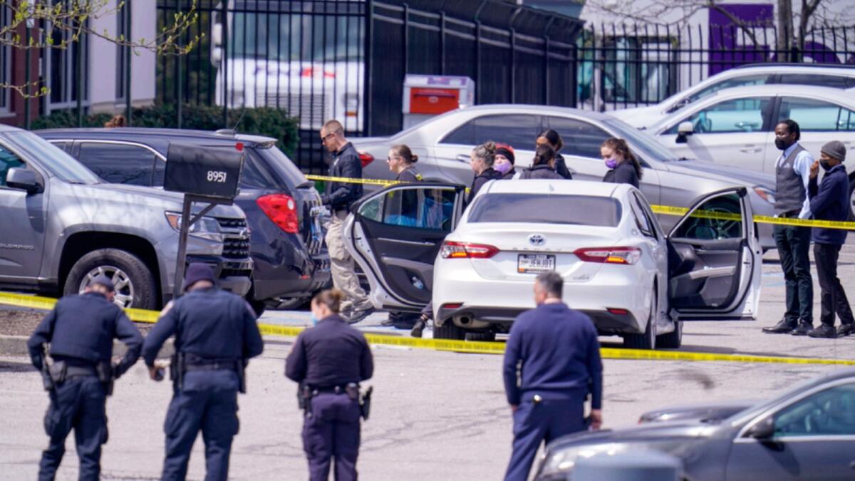 Law enforcement officers in front of the FedEx facility in Indianapolis, where a 19-year-old former employee shot eight people to death. — AP