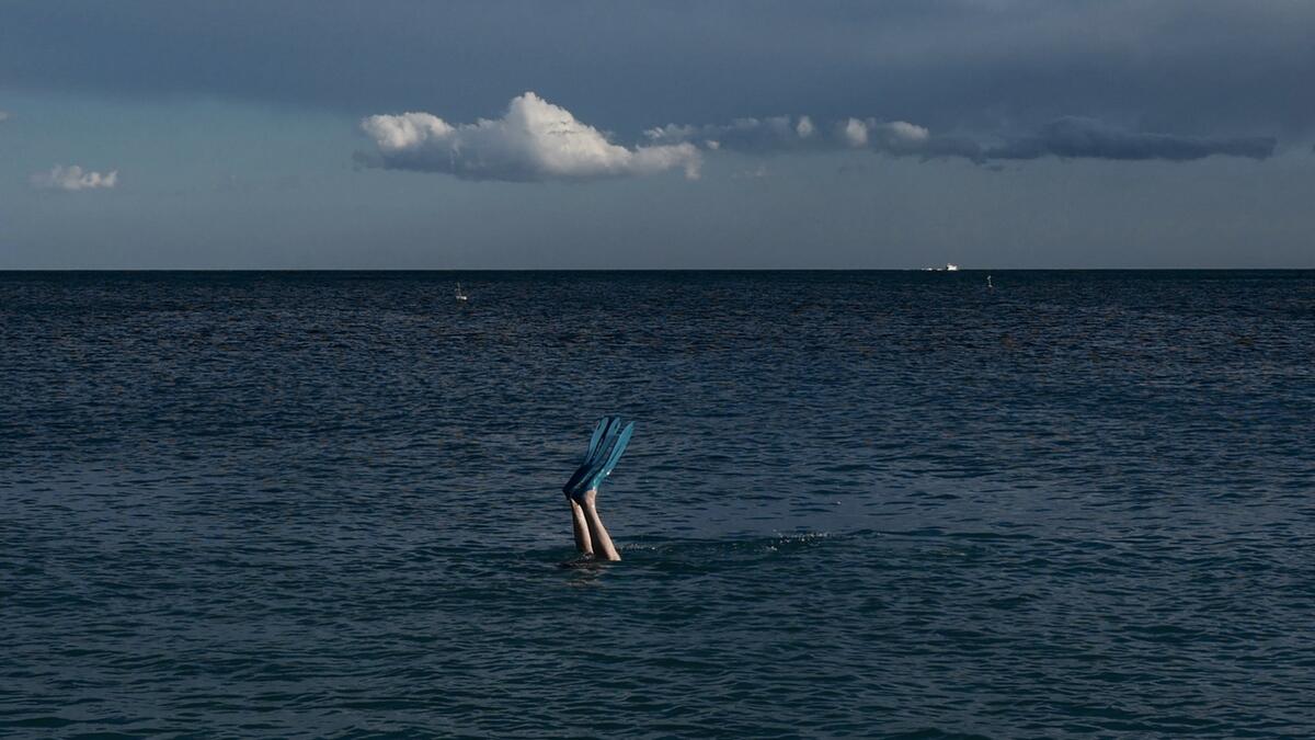 A man swims with fins in the Mediterranean Sea in the French riviera city of Nice. Photo: AFP