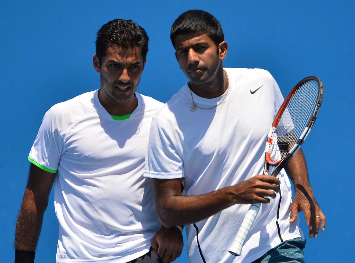 Pakistan's Aisam-Ul-Haq Qureshi (left) with partner India's Rohan Bopanna at the Australian Open in 2014. — AFP file