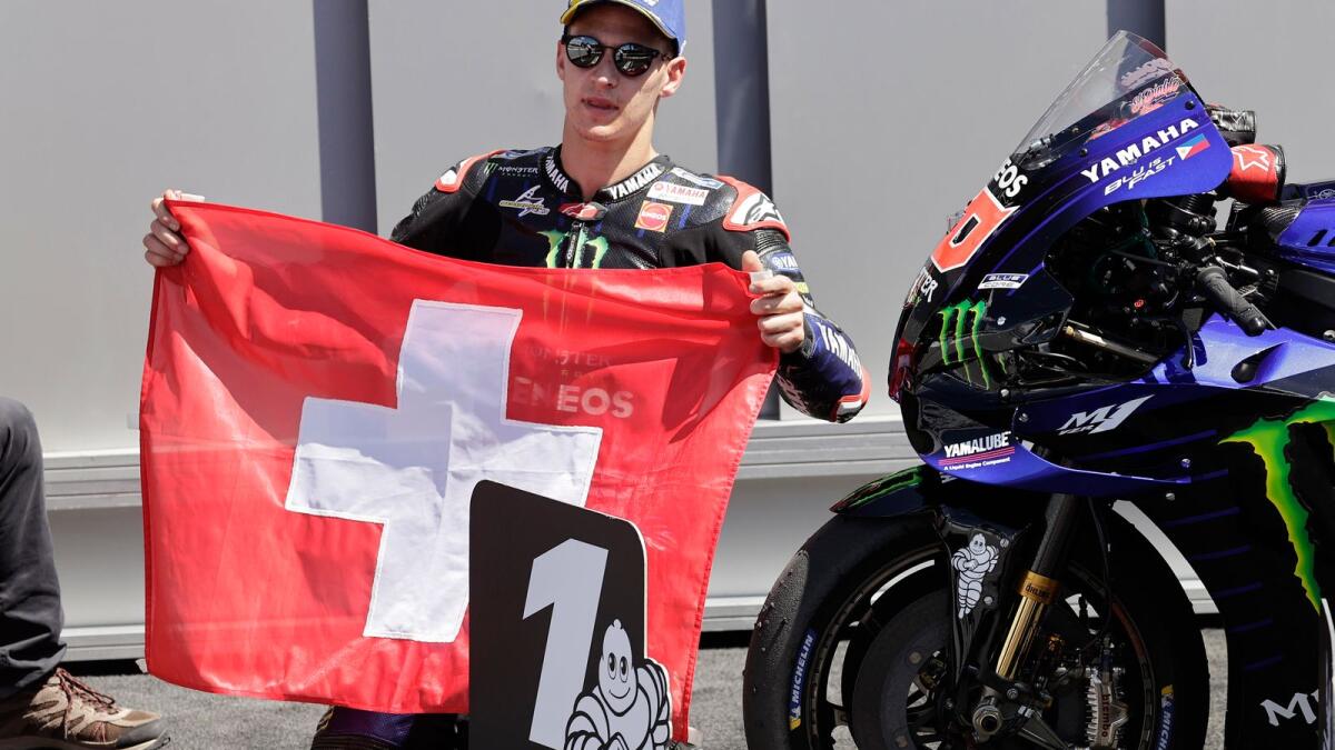 Monster Energy Yamaha MotoGP's Fabio Quartararo holds a Switzerland flag after winning the race as a tribute to Moto3 rider Jason Dupasquier who died from injuries sustained in yesterday's qualifying. — Reuters