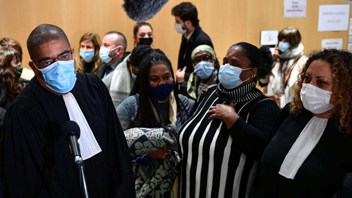 The lawyer of Clarissa Jean-Philippe's family, a French policewoman killed on January 8, 2015, Laurent Hatchi (L) talks to the press at the Paris' courthouse on December 16, 2020.