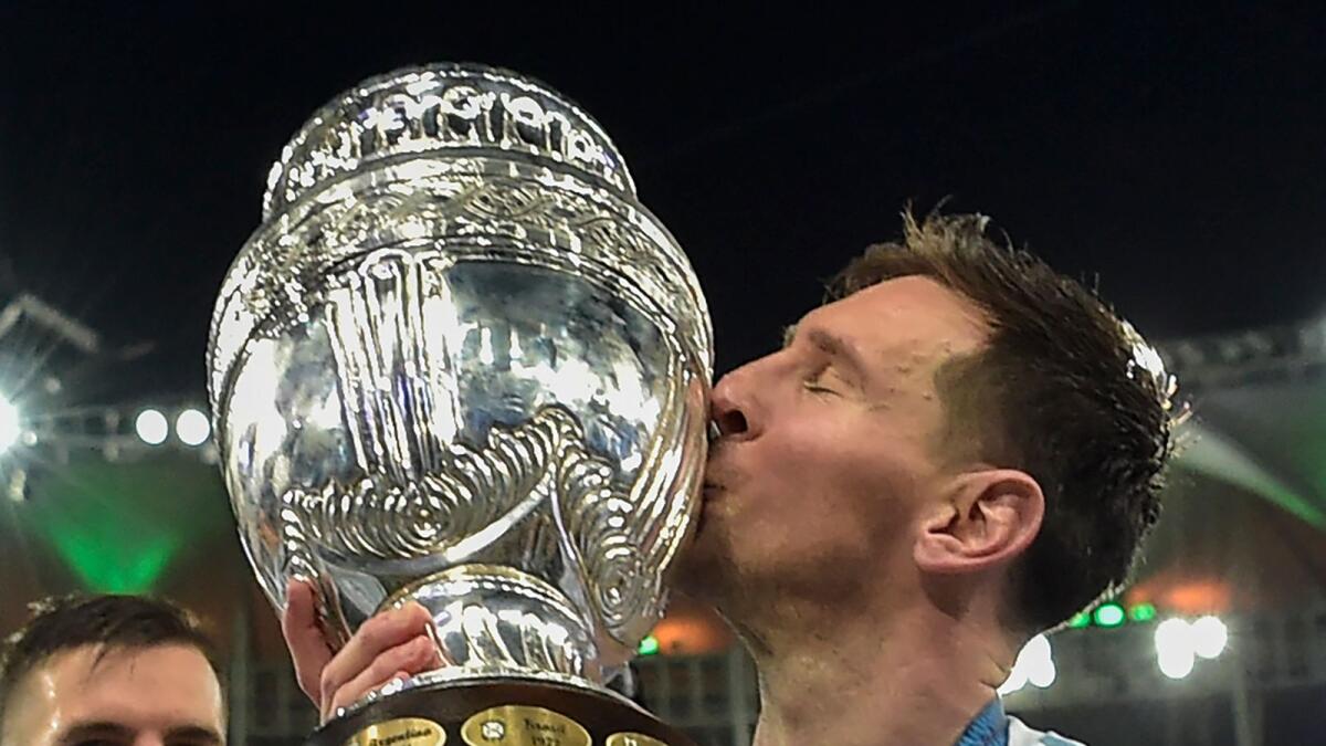 Argentina's Lionel Messi kisses the trophy after winning the Copa America final against Brazil. (AFP)