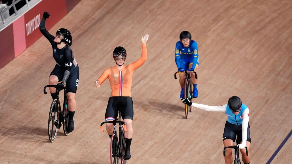 Shanne Braspennincx of Team Netherlands (centre) crosses the line to win the gold medal as Ellesse Andrews of Team New Zealand (left) wins silver and Lauriane Genest of Team Canada (right) wins bronze, during the track cycling women's keirin at the 2020 Summer Olympics. — AP