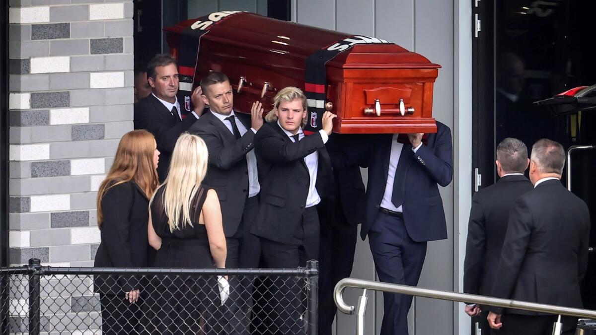The coffin of Australian cricket superstar Shane Warne is carried by his son Jackson (C) and others after a private memorial service at the St Kilda Football Club in Melbourne on March 20, 2022. Photo: AFP